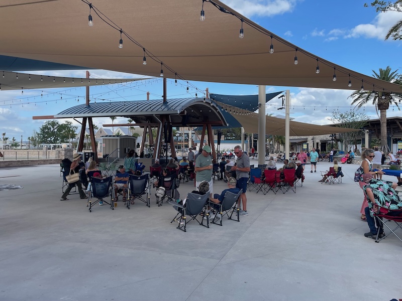 Eastport square dining and entertainment area with restaurants, string lights and seating in The Villages